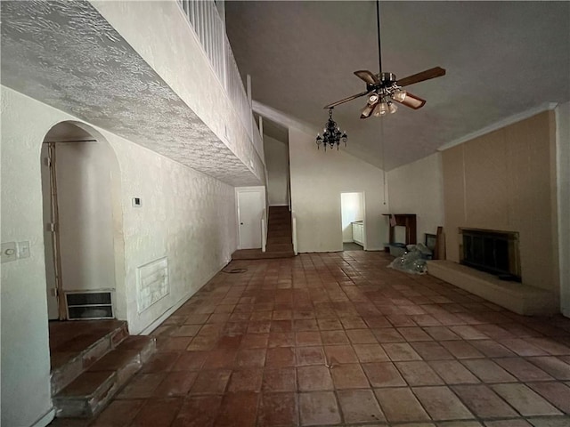 unfurnished living room featuring ceiling fan and high vaulted ceiling