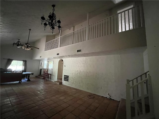 interior space with pool table, ceiling fan, and a high ceiling