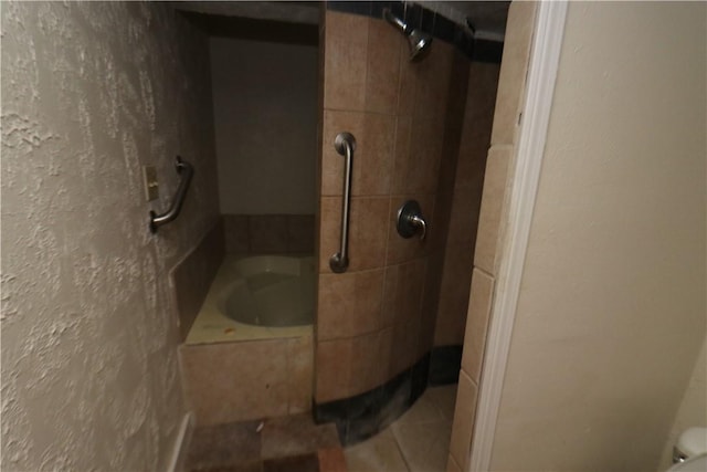 bathroom with tile patterned floors and tiled shower / bath combo