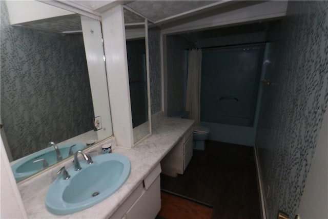 bathroom with walk in shower, vanity, and toilet