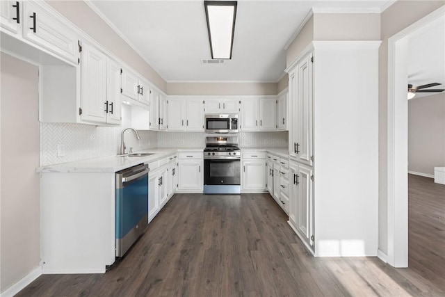 kitchen featuring white cabinetry, ceiling fan, stainless steel appliances, tasteful backsplash, and sink