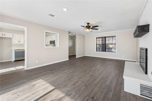 unfurnished living room featuring ceiling fan and dark hardwood / wood-style floors