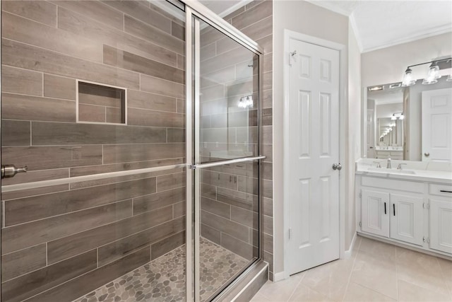 bathroom with an enclosed shower, vanity, and tile patterned flooring