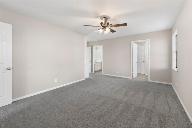 unfurnished room with ceiling fan and dark carpet