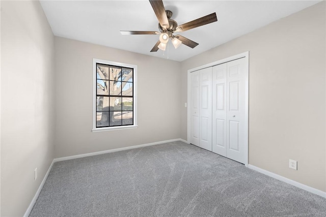 unfurnished bedroom with ceiling fan, a closet, and carpet floors