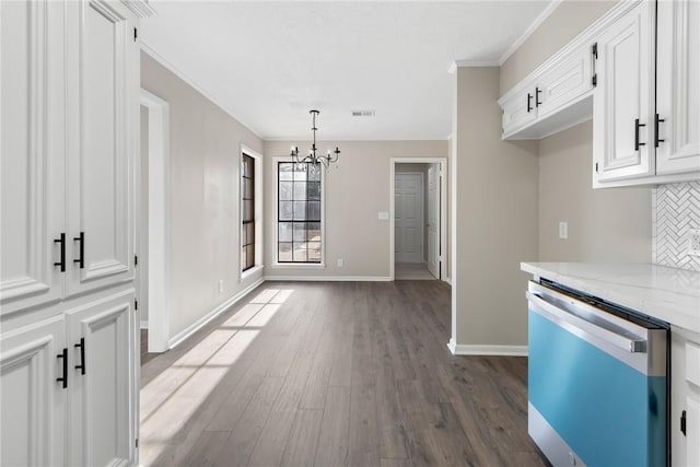 kitchen with backsplash, light stone countertops, white cabinets, and stainless steel dishwasher