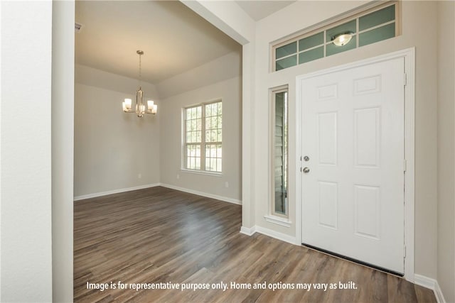 foyer entrance featuring a notable chandelier and dark wood-type flooring