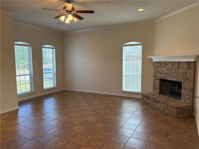 unfurnished living room featuring a fireplace, dark tile patterned flooring, ceiling fan, and crown molding