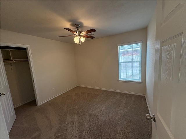 unfurnished bedroom featuring ceiling fan, a closet, and carpet