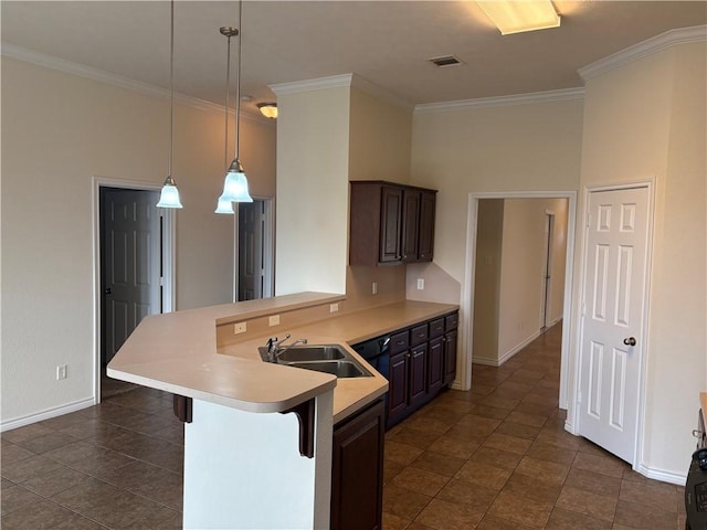 kitchen with a breakfast bar, sink, decorative light fixtures, dark brown cabinets, and kitchen peninsula