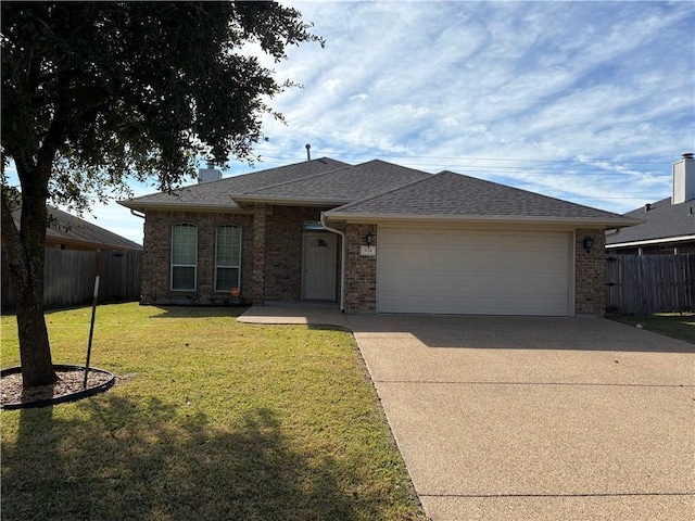 view of front of property with a garage and a front lawn