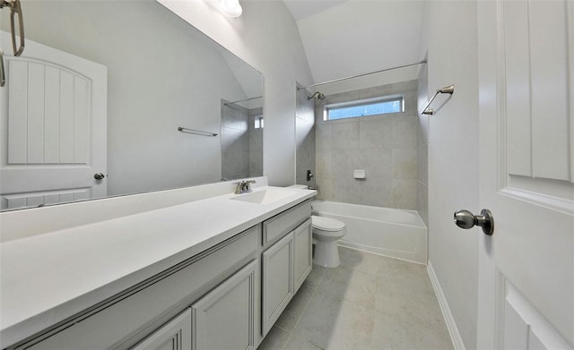 full bathroom featuring tiled shower / bath, tile patterned floors, vanity, toilet, and vaulted ceiling