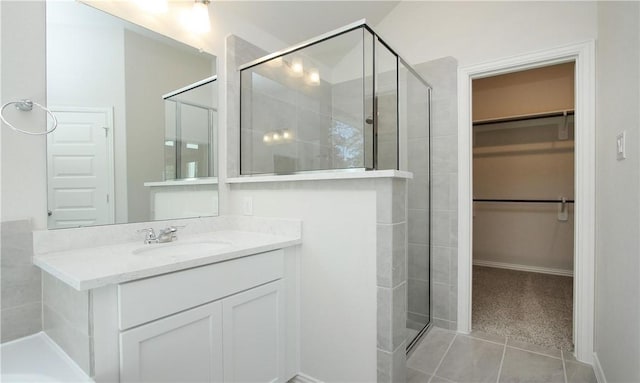 bathroom featuring vanity, a shower with door, and tile patterned flooring