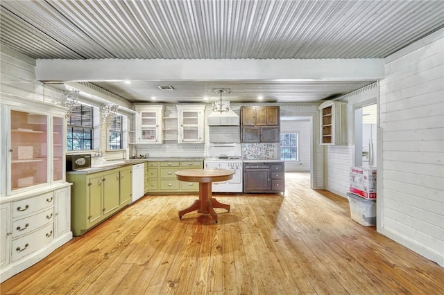 23405 Martha Williams Rd, Montgomery, TX 77356 - kitchen with stove, white dishwasher, light wood finished floors, light countertops, and a sink