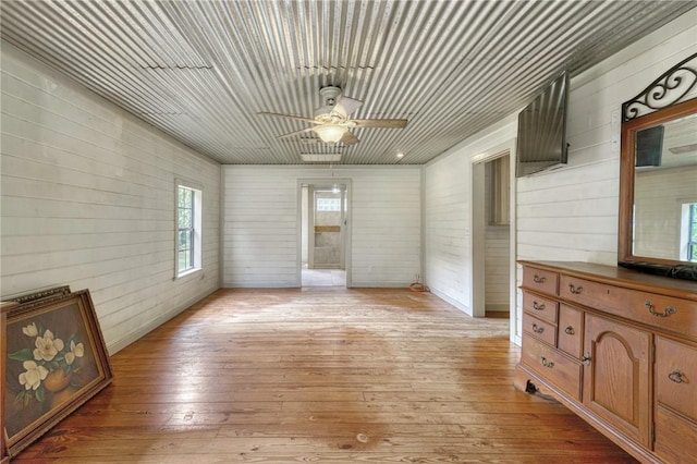 23405 Martha Williams Rd, Montgomery, TX 77356 - unfurnished living room featuring a ceiling fan, light wood finished floors, wood walls, and wood ceiling