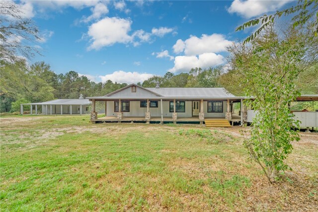 23405 Martha Williams Rd, Montgomery, TX 77356 - back of house with a lawn, a carport, and covered porch