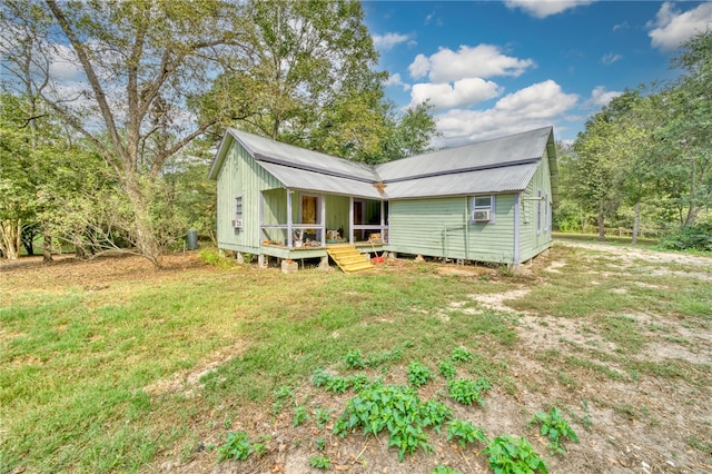 23405 Martha Williams Rd, Montgomery, TX 77356 - rear view of house with a deck, metal roof, and a yard