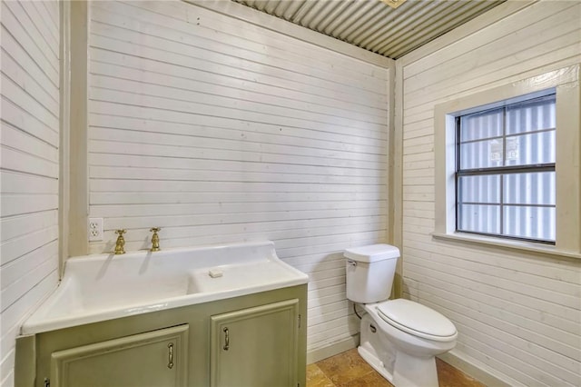 23405 Martha Williams Rd, Montgomery, TX 77356 - bathroom with toilet, wooden walls, and vanity