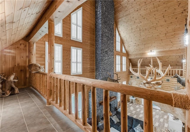 206 22 Hills Rd, Gause, TX 77857 - hallway with high vaulted ceiling, wooden walls, tile patterned floors, and wood ceiling