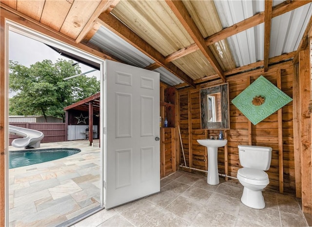 206 22 Hills Rd, Gause, TX 77857 - bathroom featuring wooden walls and stone finish flooring