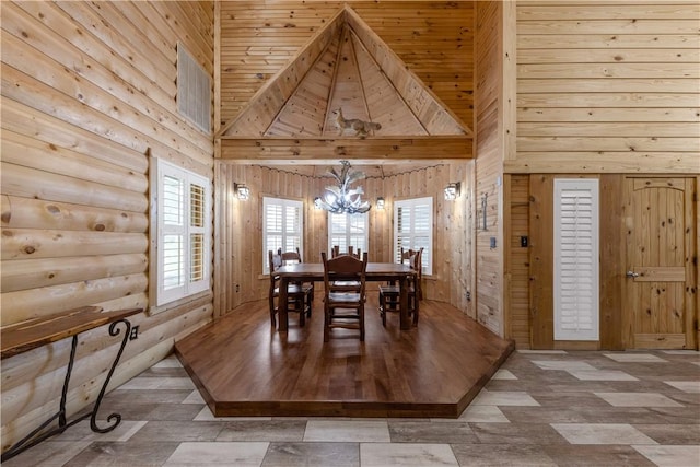 206 22 Hills Rd, Gause, TX 77857 - dining area with a chandelier, wooden walls, and a towering ceiling
