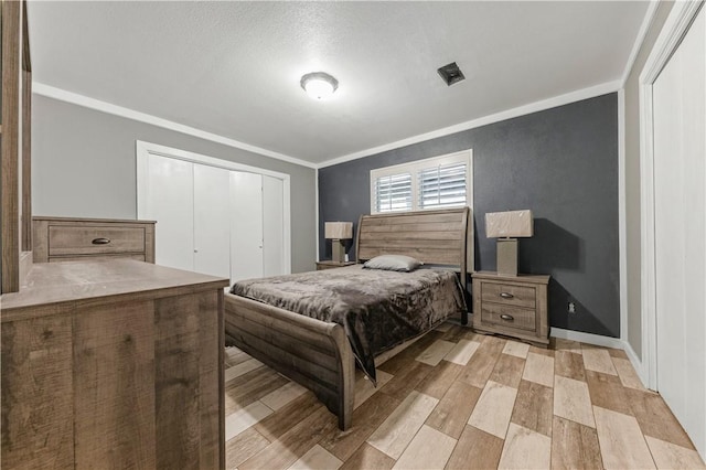 206 22 Hills Rd, Gause, TX 77857 - bedroom with ornamental molding, a closet, and light wood-style floors