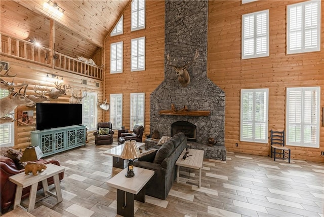 206 22 Hills Rd, Gause, TX 77857 - living area with high vaulted ceiling, a stone fireplace, wooden ceiling, and wood finished floors