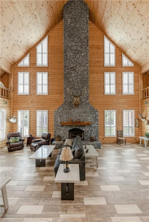 206 22 Hills Rd, Gause, TX 77857 - living area featuring high vaulted ceiling, a fireplace, wood ceiling, and wooden walls