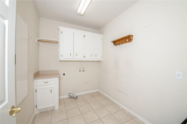 clothes washing area featuring hookup for an electric dryer, hookup for a washing machine, cabinets, and light tile patterned flooring