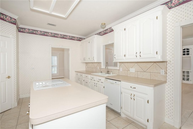 kitchen with dishwasher, crown molding, sink, light tile patterned floors, and white cabinetry