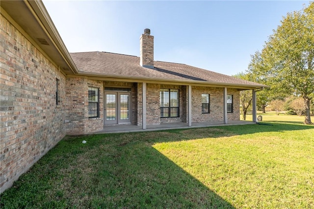 back of house featuring a yard