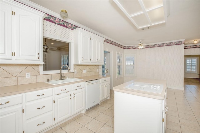 kitchen with dishwasher, white cabinetry, crown molding, and sink