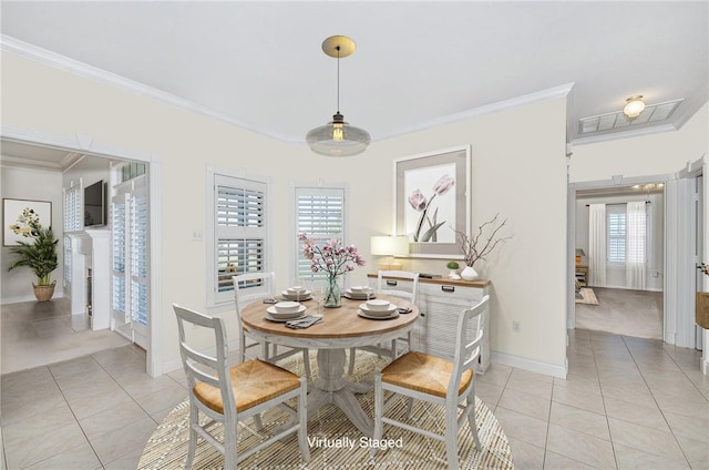 dining room featuring ornamental molding and light tile patterned floors