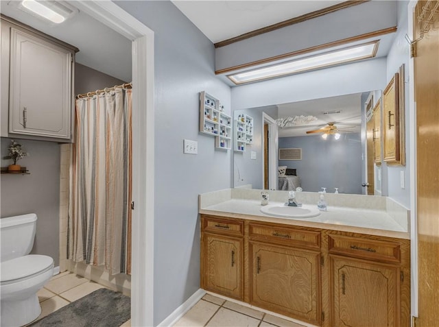 bathroom with tile patterned floors, toilet, vanity, a shower with shower curtain, and ceiling fan