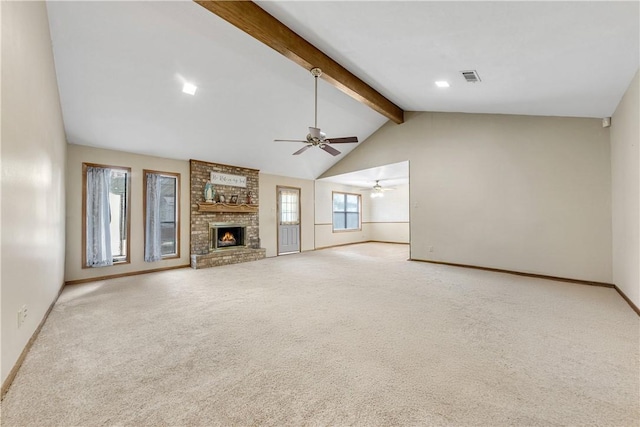 unfurnished living room with lofted ceiling with beams, a fireplace, light carpet, and ceiling fan