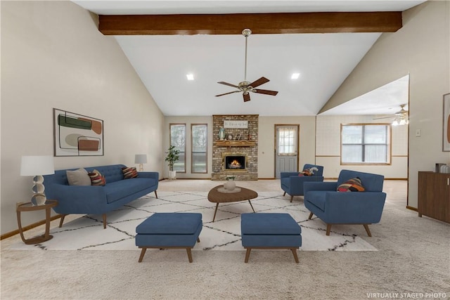 living room featuring beam ceiling, ceiling fan, light colored carpet, and a fireplace