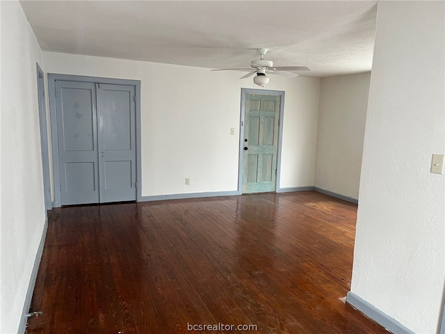 spare room featuring ceiling fan and dark hardwood / wood-style flooring