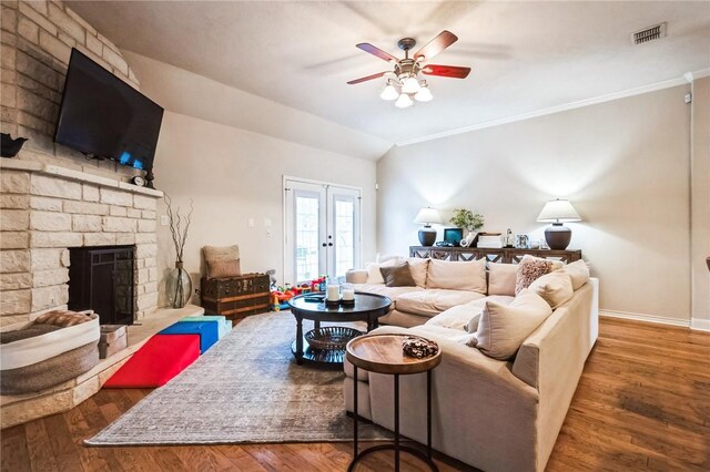 living room with visible vents, a brick fireplace, wood finished floors, and french doors