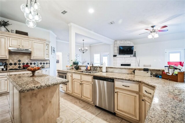 kitchen with visible vents, a sink, decorative backsplash, under cabinet range hood, and dishwasher