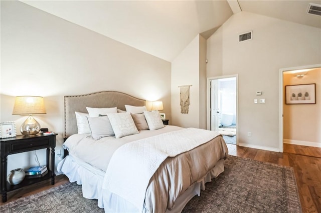 bedroom with connected bathroom, wood finished floors, visible vents, and baseboards