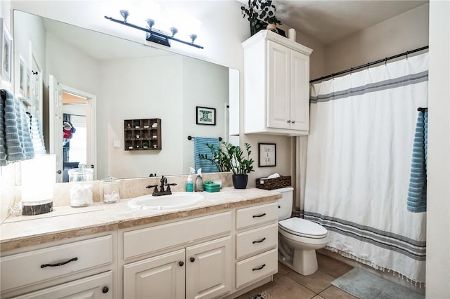 bathroom featuring tile patterned floors, toilet, and vanity