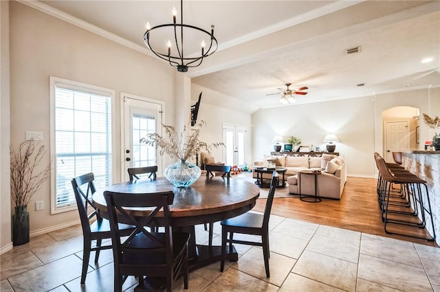 dining space featuring visible vents, arched walkways, ornamental molding, french doors, and ceiling fan with notable chandelier