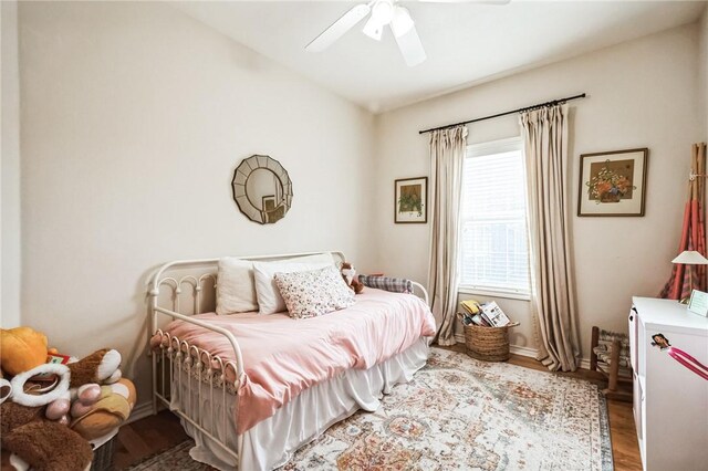 bedroom featuring a ceiling fan and wood finished floors