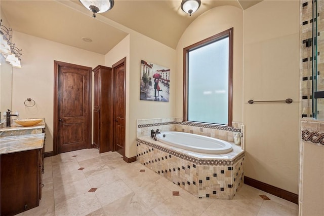 bathroom with a garden tub, tile patterned floors, baseboards, walk in shower, and vanity