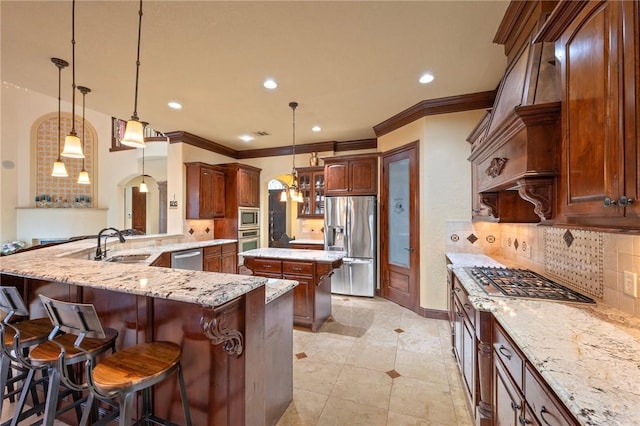 kitchen with a sink, stainless steel appliances, tasteful backsplash, crown molding, and a kitchen island