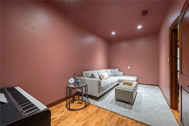 living area with visible vents, wood finished floors, baseboards, and recessed lighting