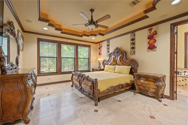 bedroom with baseboards, visible vents, a tray ceiling, and crown molding