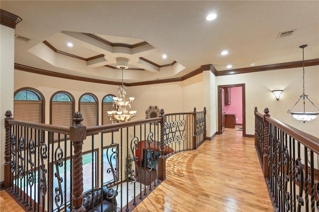 hallway with baseboards, an inviting chandelier, crown molding, and wood finished floors