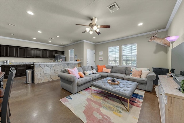 living room featuring ceiling fan, crown molding, and concrete flooring