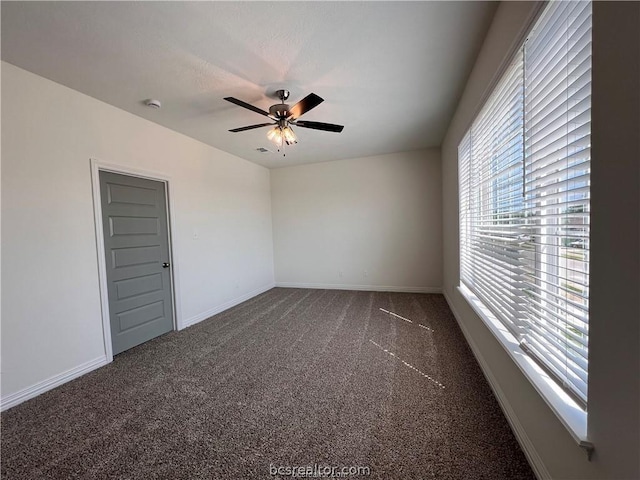 carpeted empty room featuring ceiling fan